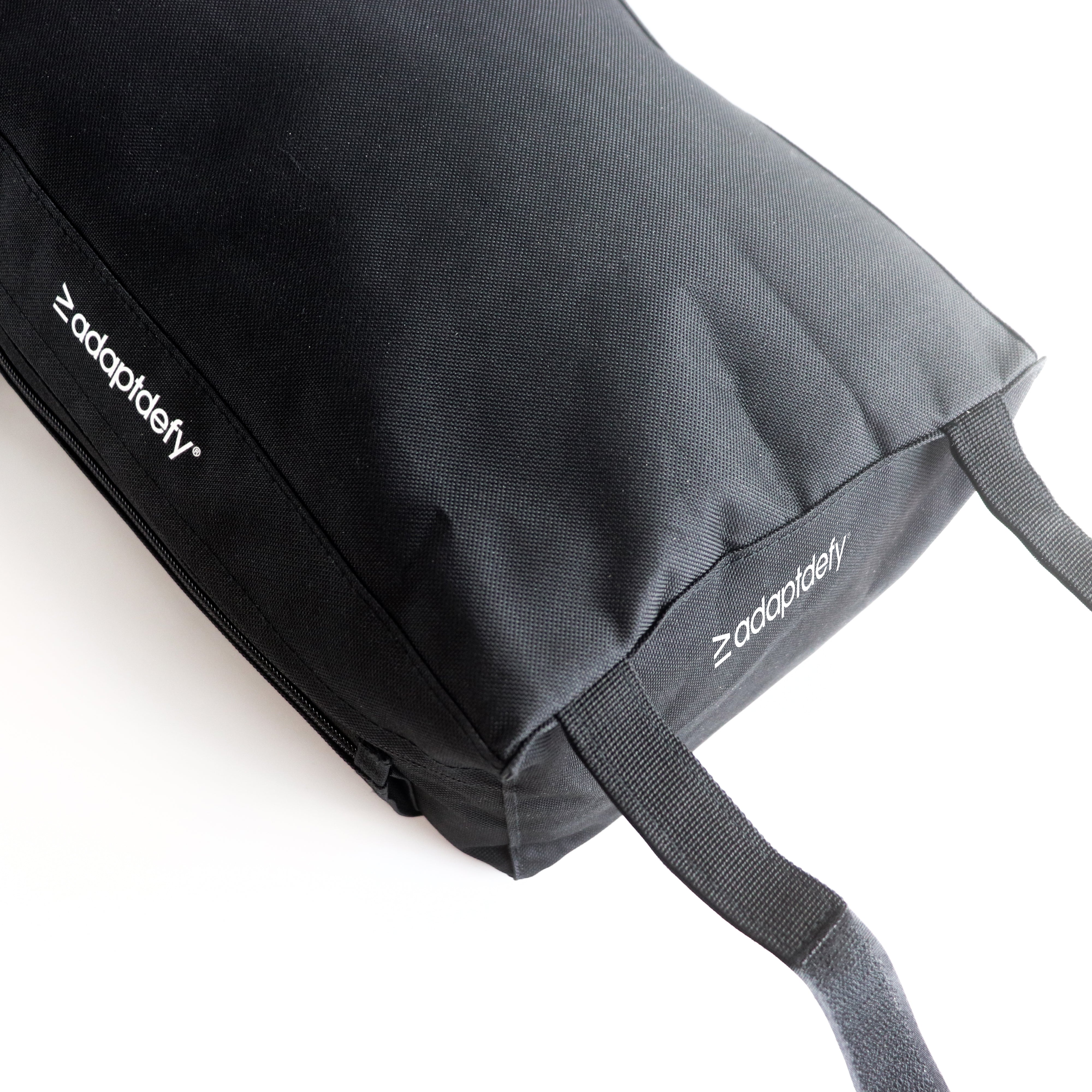 Black wheelchair bag with 'adaptdefy' branding on a white background. velcro straps and undone