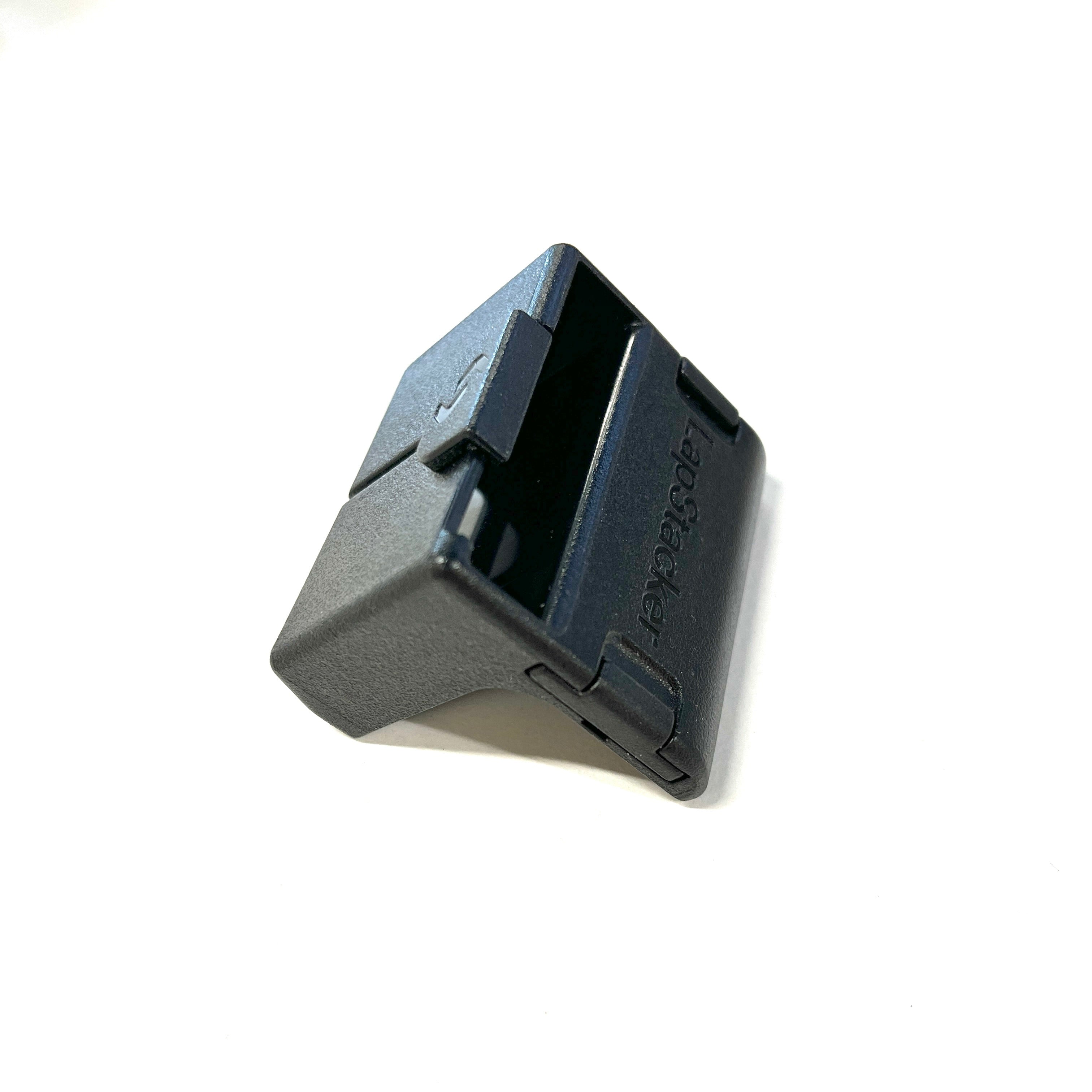 Black LapStacker Flex Flush Buckle Holder plastic component on a white background
