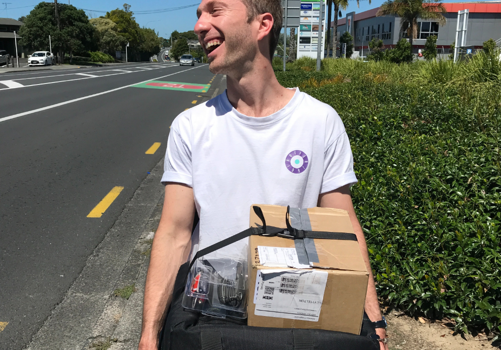 Man using LapStacker on a manual wheelchair to carry a box and packages outside