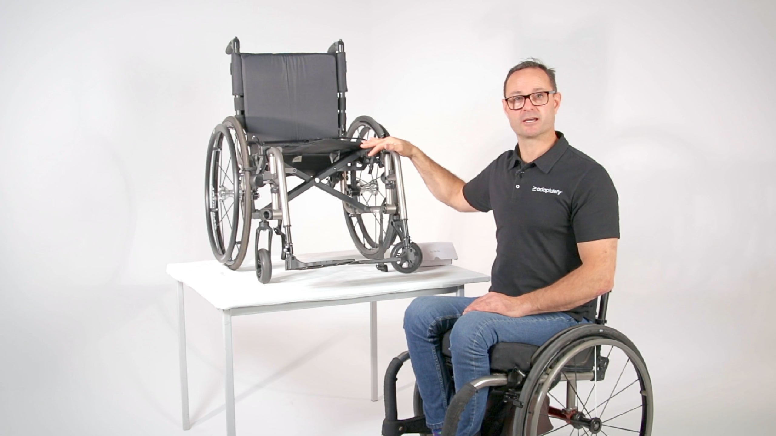 A man in a wheelchair shows you how to install a LapStacker Flex horizontally on a manual folding wheelchair. This is specifically for a single-frame folding wheelchair. 