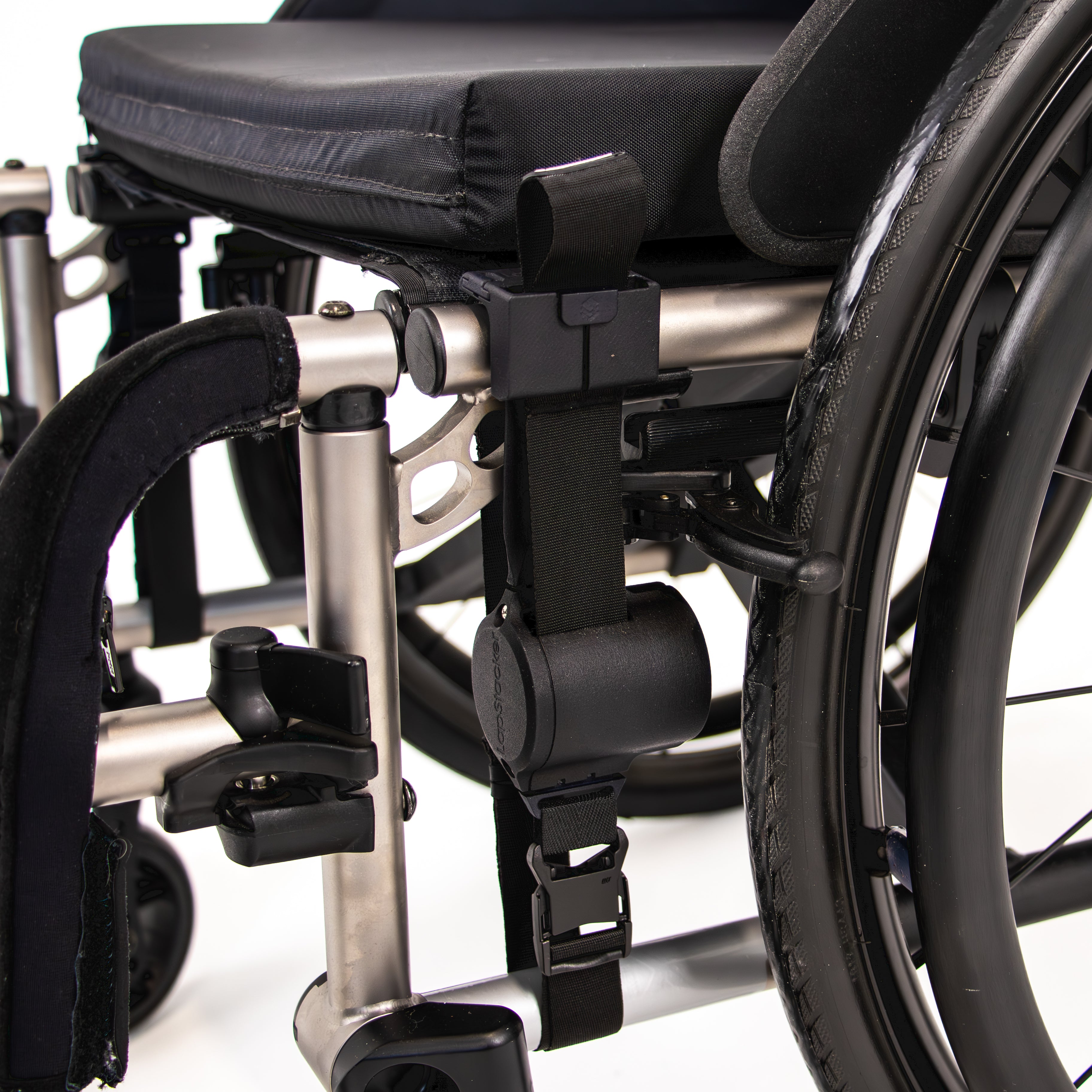 Side view of folding manual wheelchair with LapStacker Flex installed vertically and discretely to the frame of the wheelchair.