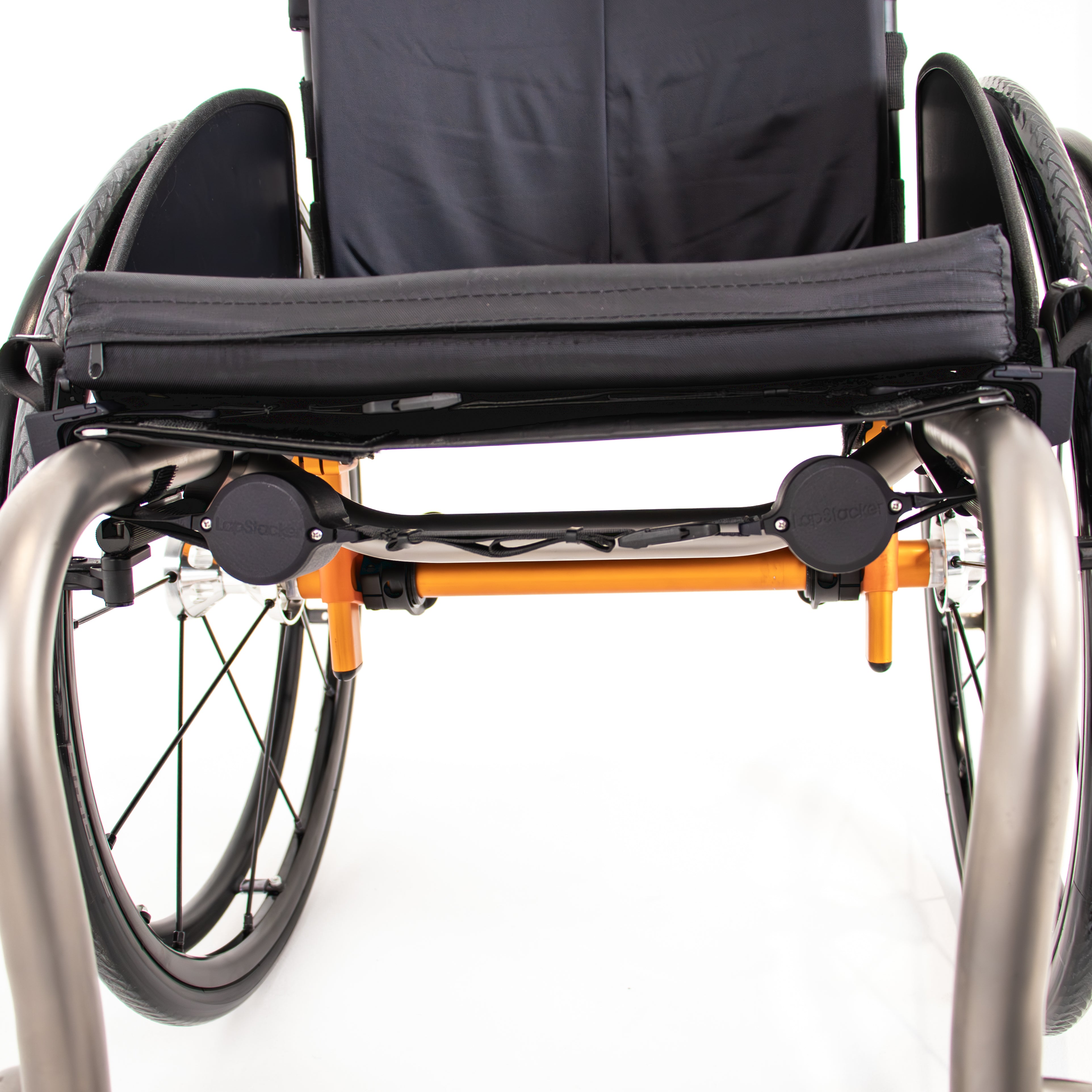 Front view of manual rigid wheelchair with LapStacker Flex installed horizontally and discretely under the seat 